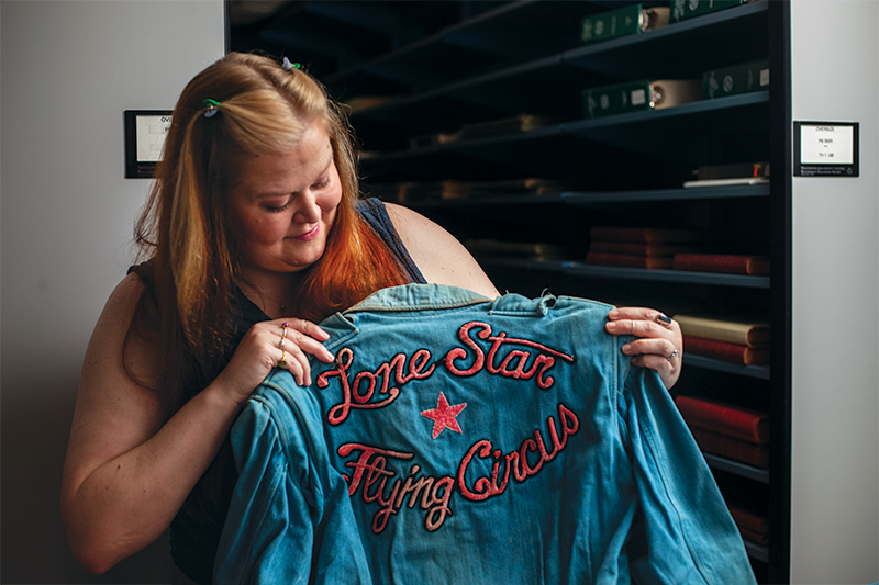 Assistant university archivist Katy Allred carefully checks an item of the Tommy Tune collection