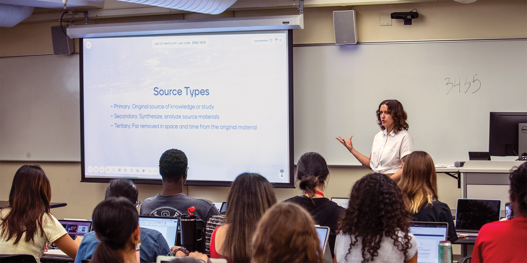 Photo of Student success librarian Carolina Hernandez teaching in front of a classroom full of students