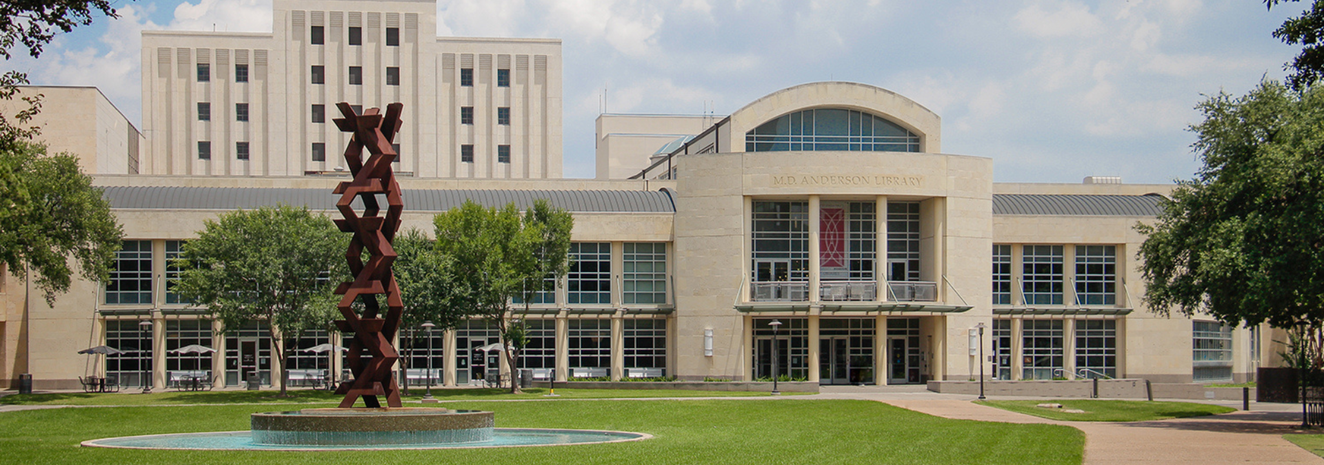 outdoor photo of the front of the MD Anderson Library building taken from Butler Plaza