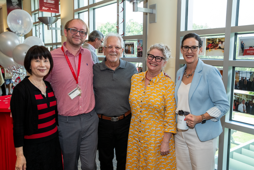 five smiling people looking at the camera
