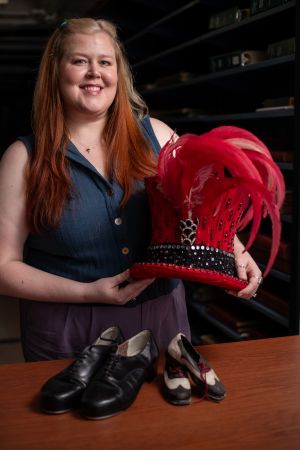 Assistant university archivist Katy Allred carefully checks each item of the Tommy Tune collection to ensure proper preservation.